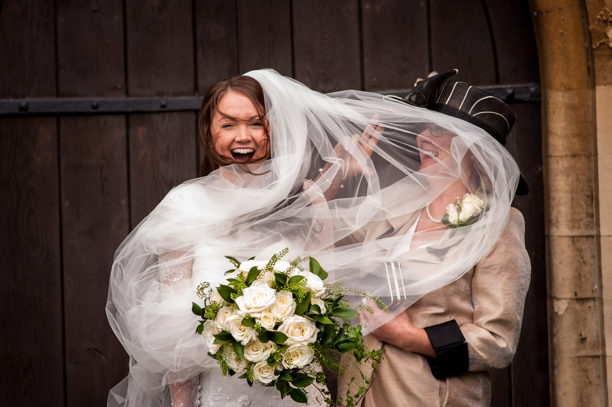 Photograph of emma's wedding veil getting caught by the wind