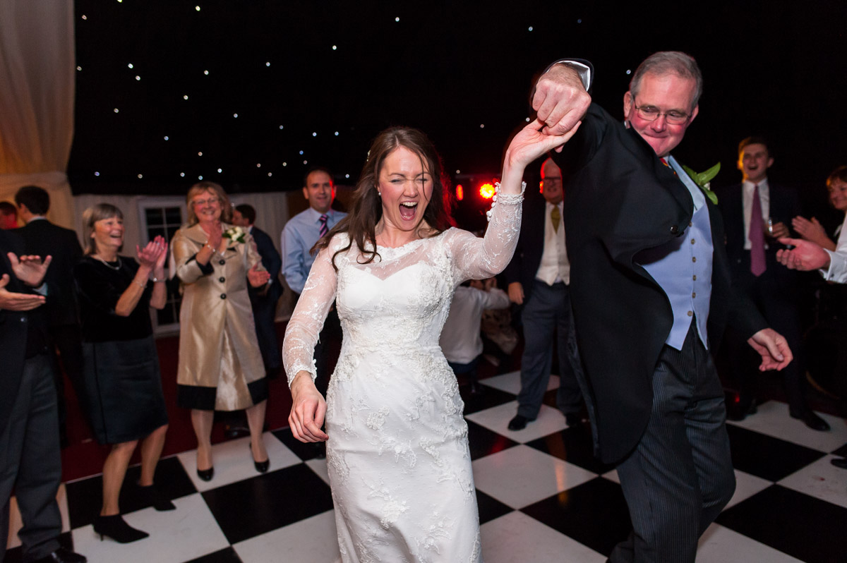 Emma enjoys a dance with her dad at her wedding