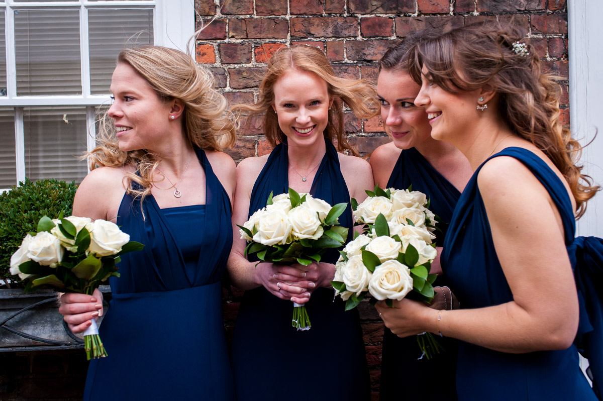Bridesmaids wait for Emma outside Kent church on her wedding day