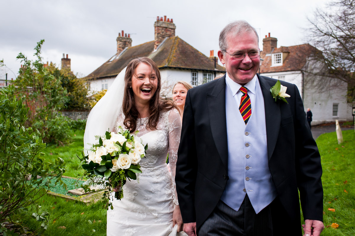 Wedding photograph of emma and her dad outside the church