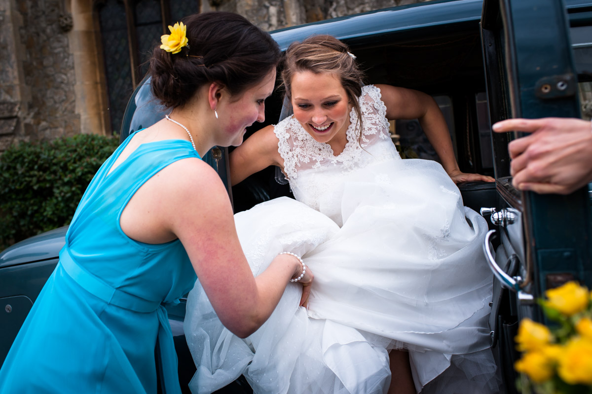 Bride getting out of wedding car for Kent church wedding