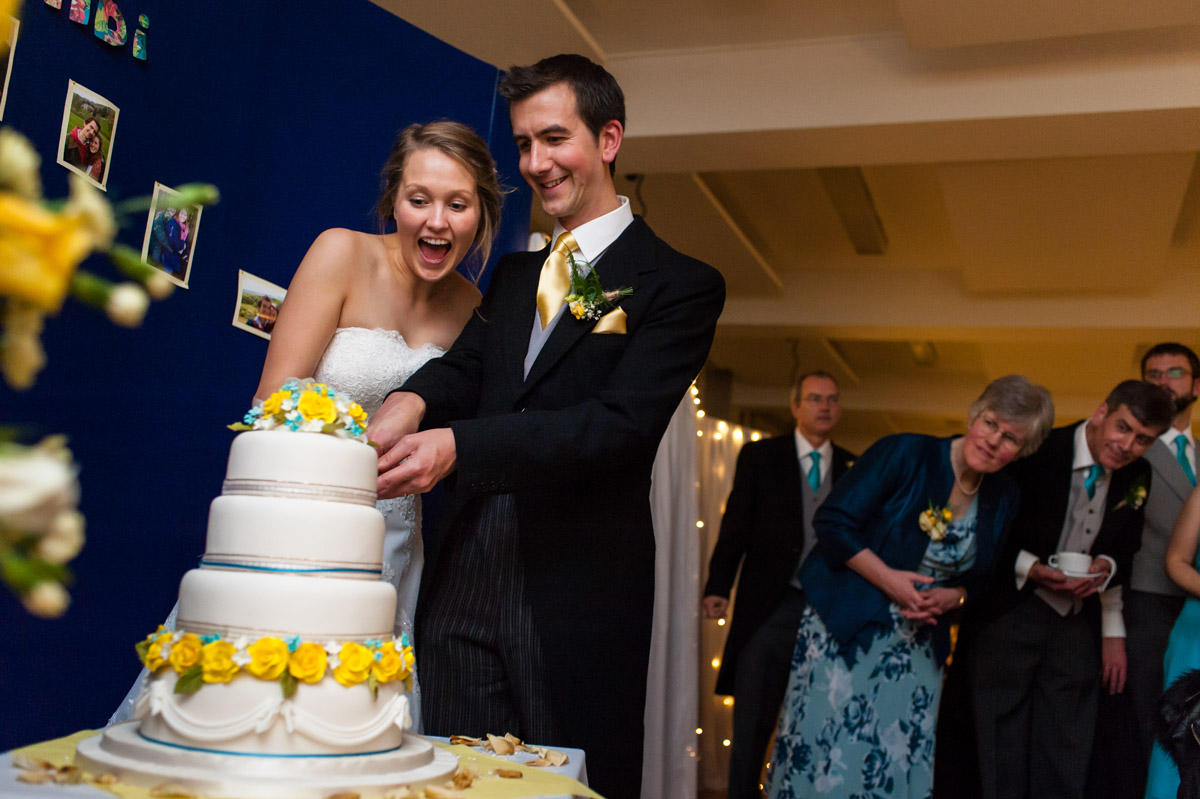 Photograph of Abigail and Peter cutting their wedding cake