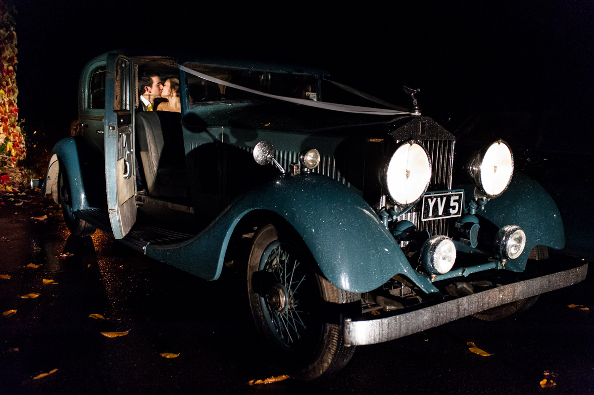 Photograph of Abigail and Peter in their wedding car at night after their Kent wedding reception