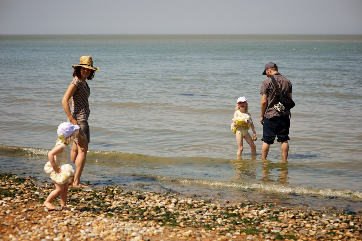 wedding guests paddle in sea at whistable