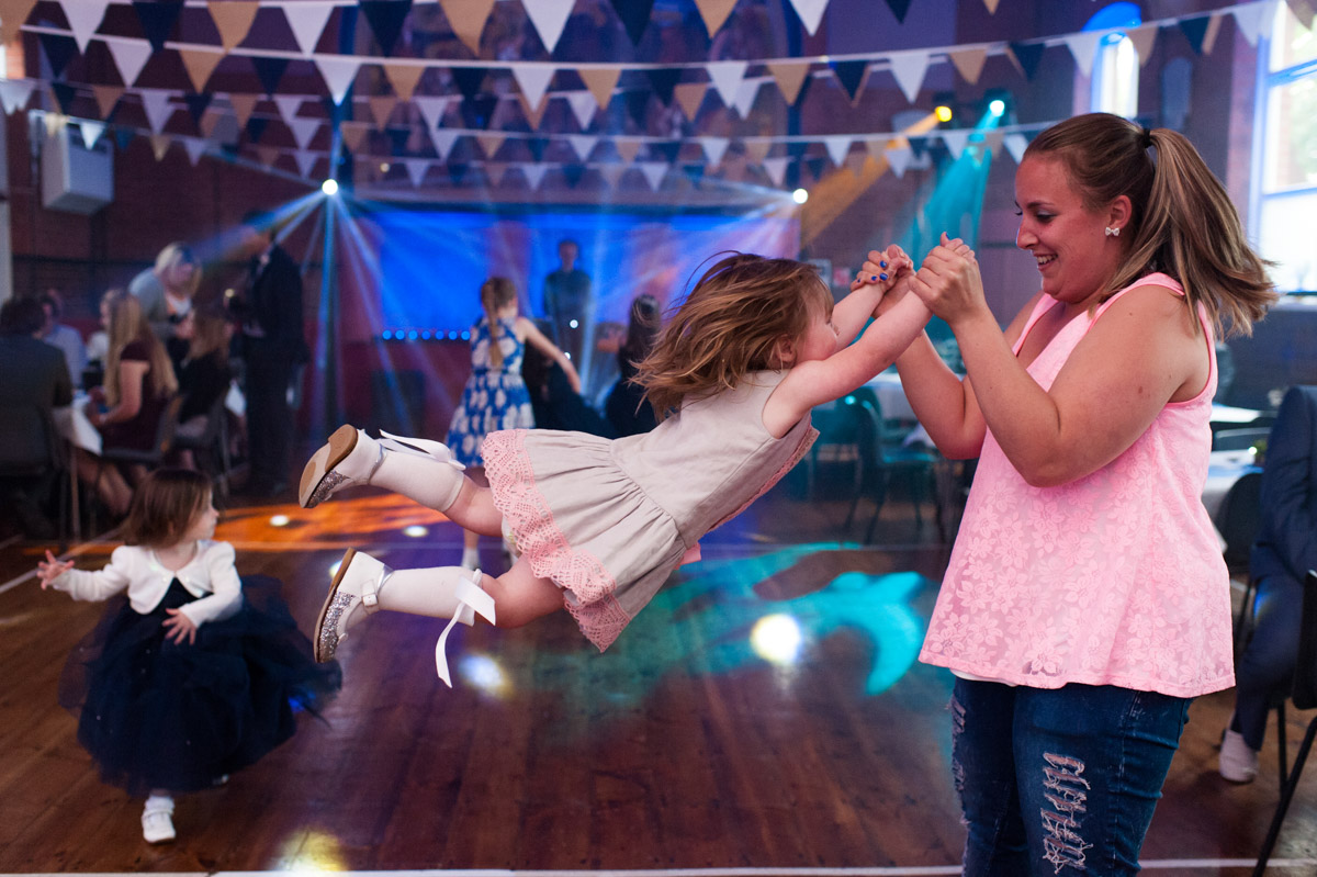 Little girl dancing at wedding reception