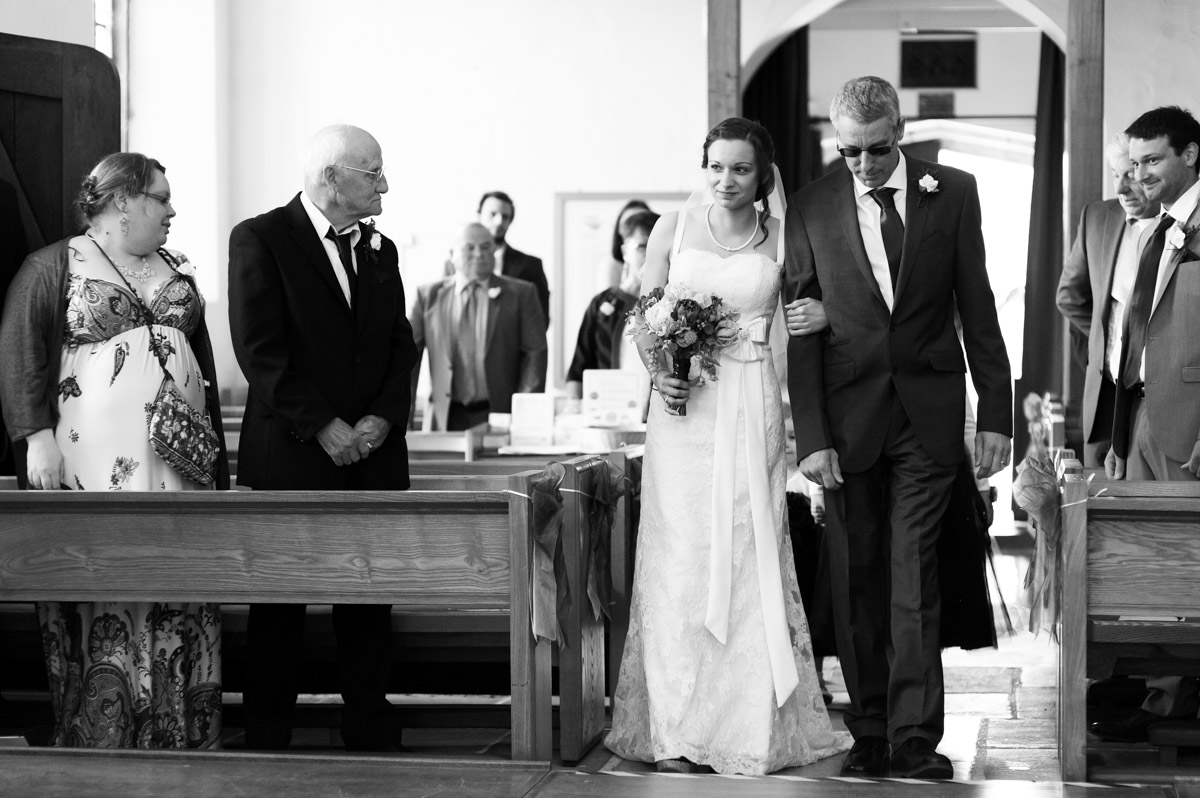 Dad and bride walk up the church aisle