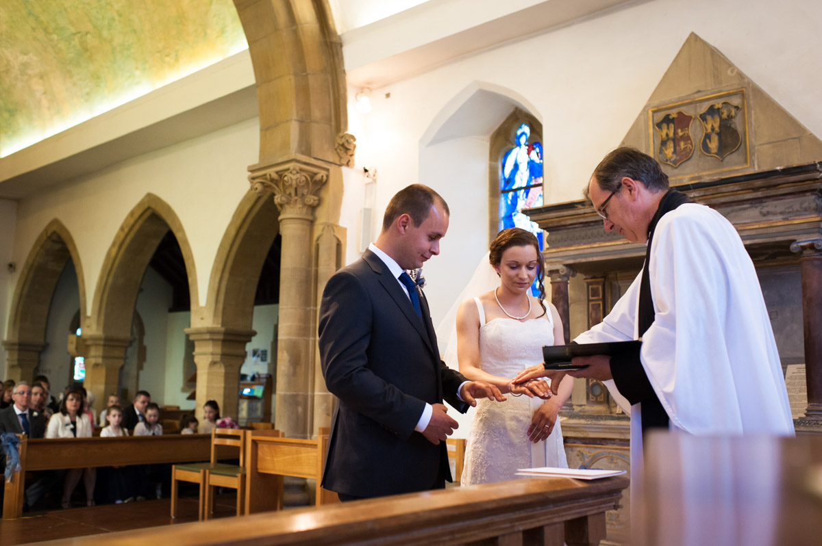 Vicar blesses bride and groom during church wedding service
