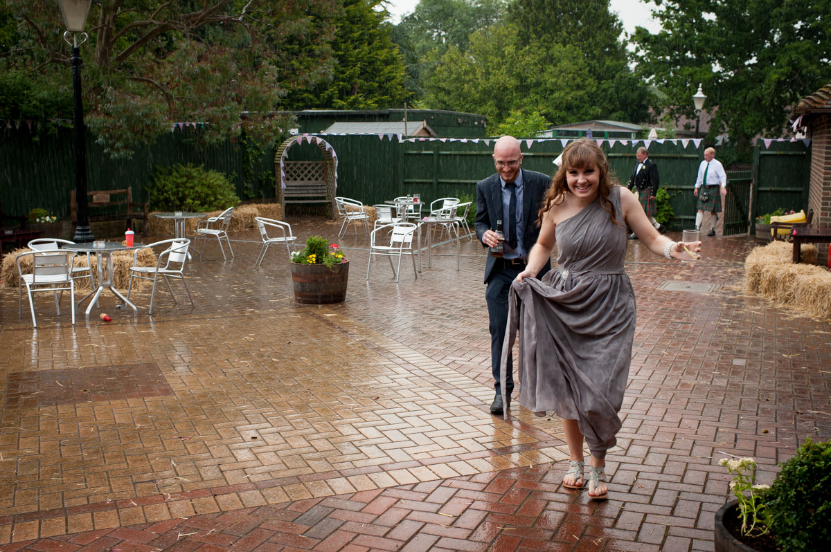 Wedding guests run in from the rain at the rare breeds centre in kent