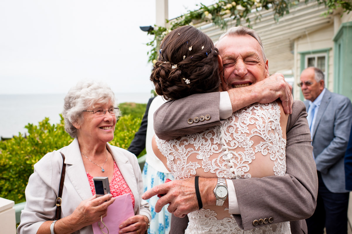 Wedding guest congratulates bride after her wedding ceremony at The Beacon House, Whitstable in Kent
