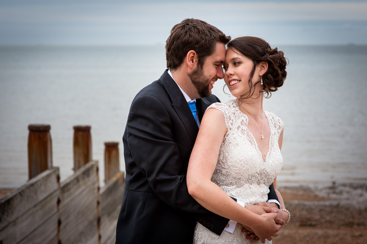 Couple photo of bride and groom on the beach at Whitstable in Kent