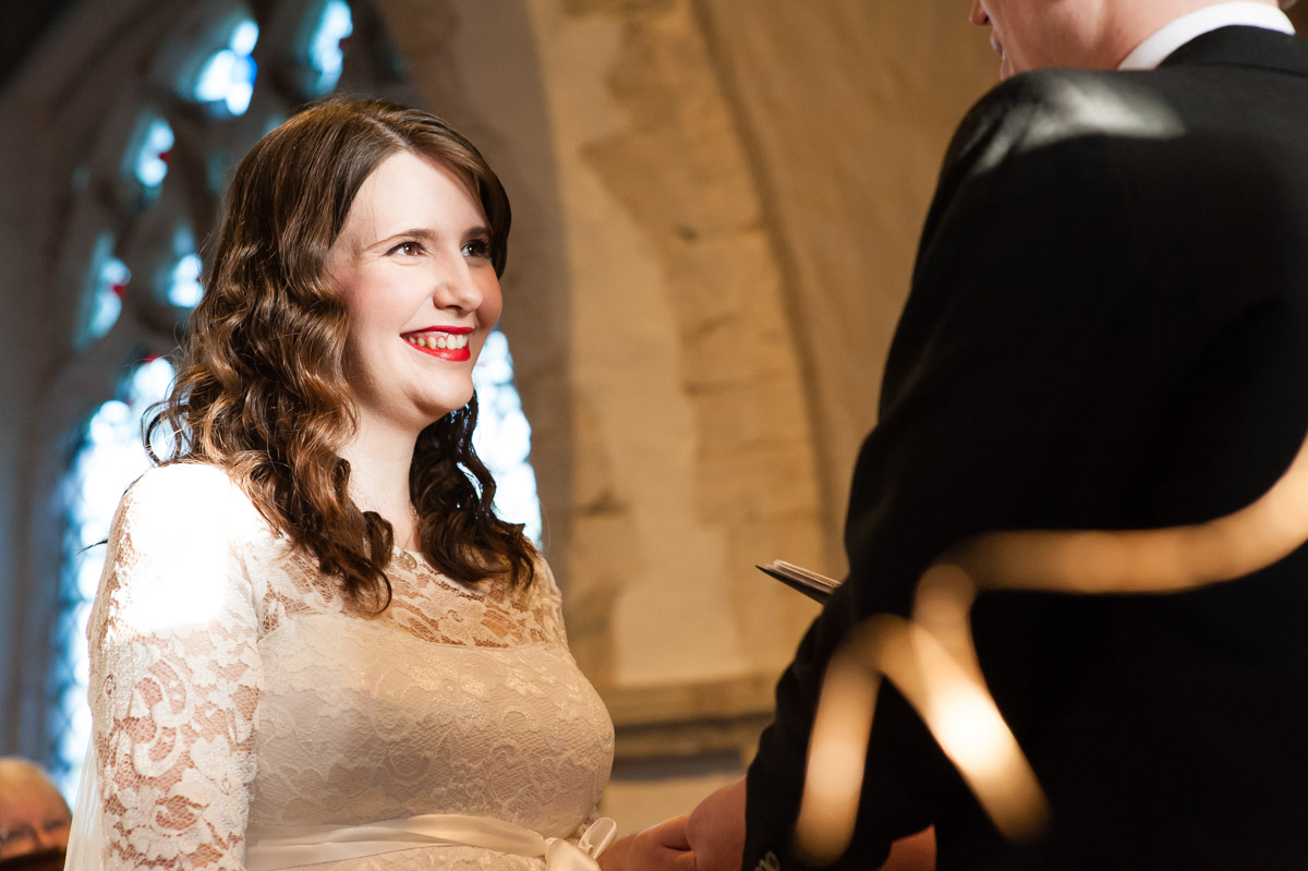 charlotte looks at mark during their kent church wedding ceremony