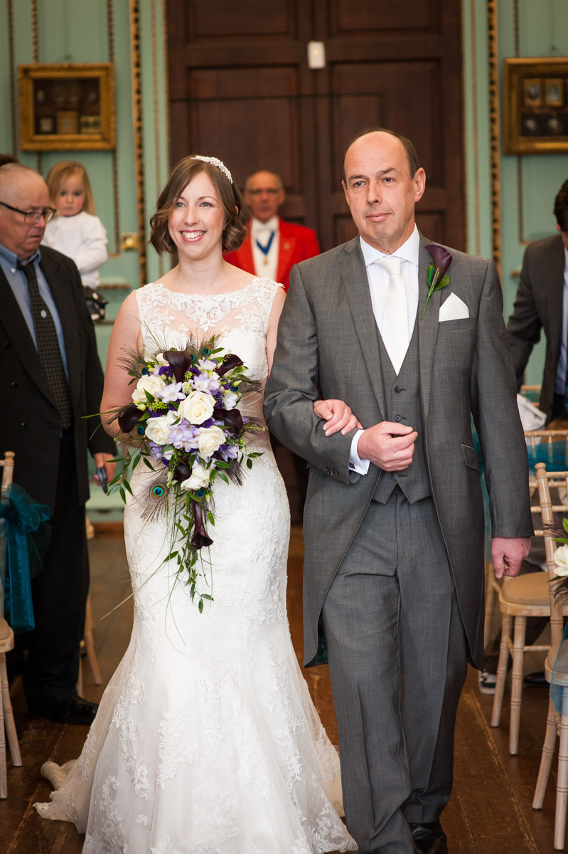 The bride is walked into The Great Hall at Bradbourne House by her father