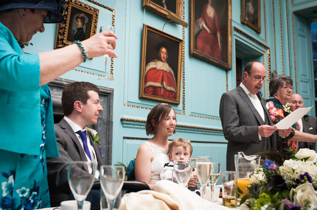 Guests toast the newly weds during their reception in The Great hall at Bradbourne House