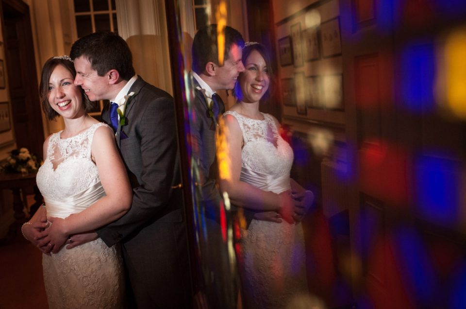 Photograph of Liz and Simon reflected in picture at their wedding at Bradbourne House in Kent