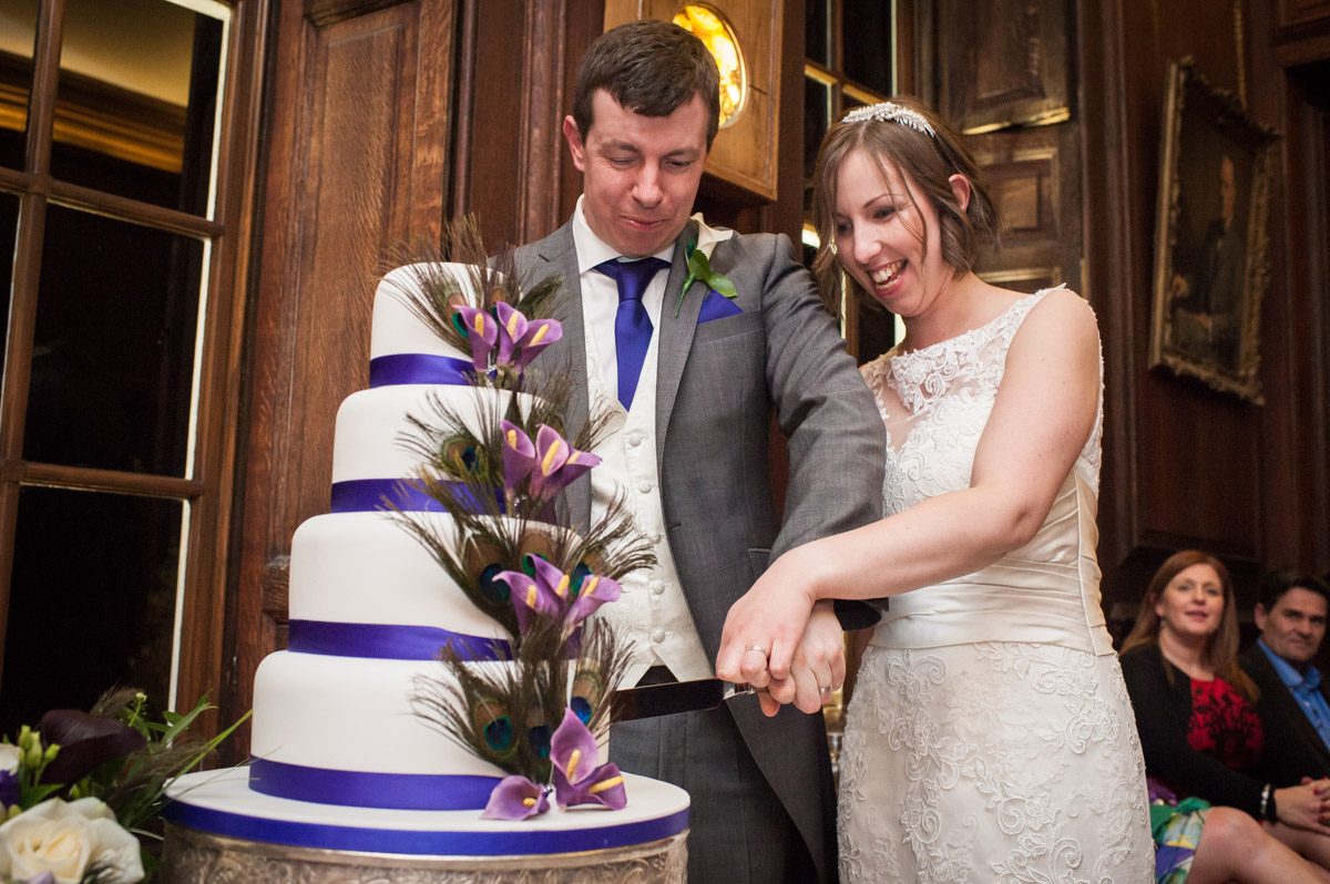 Bride and groom cut their wedding cake at Bradbourne House