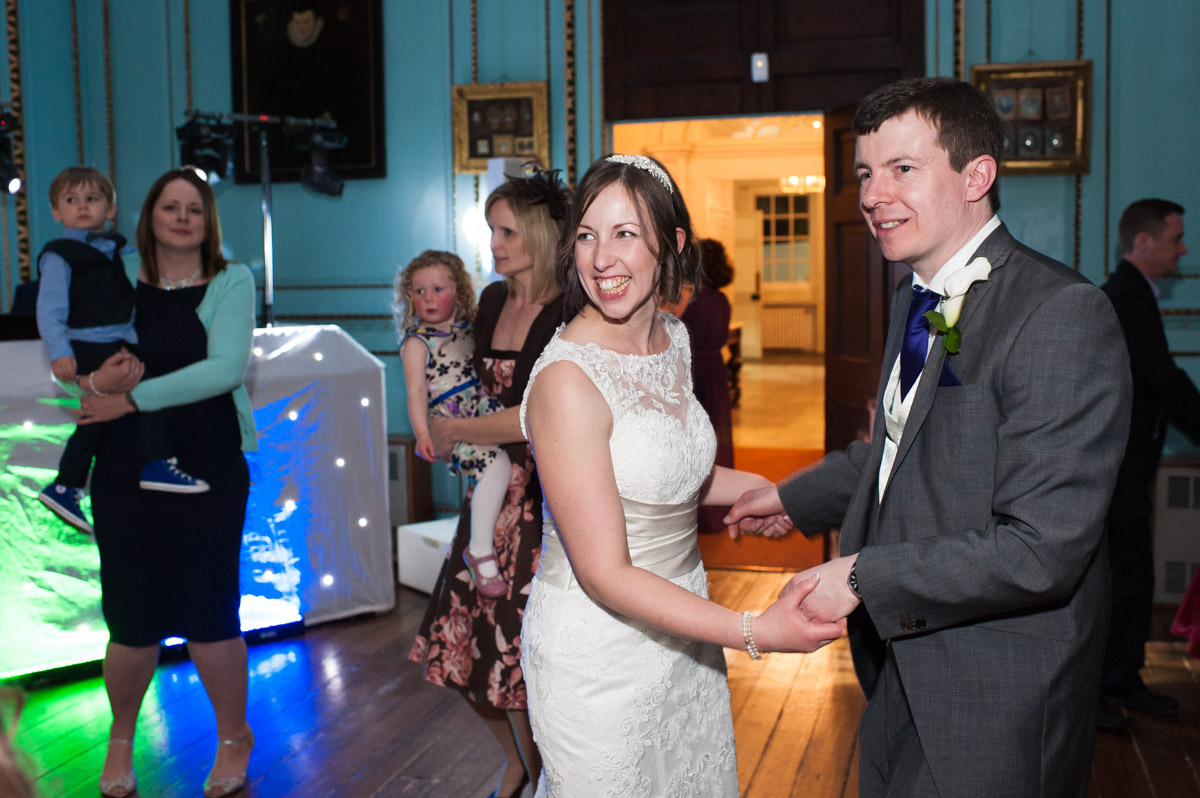 The bride and groom enjoy their first dance before wedding guests join them on the dance floor