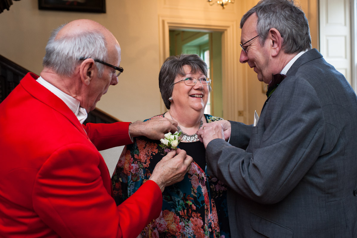 Toast master helps put on button holes at Bradbourne House wedding