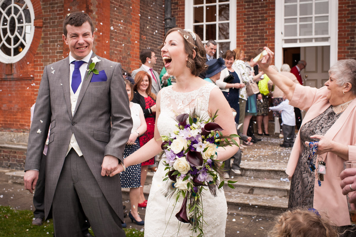 The newly married couple have confetti thrown on them by guest at Bradbourne House