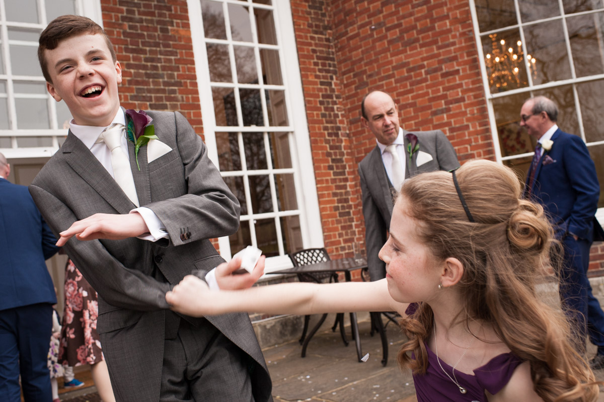 Brother and sister mess about after the confetti photo at Bradbourne House