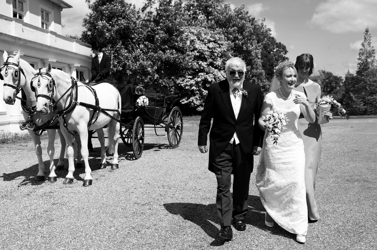 Katie is walked to the church by her father on her wedding day in Kent