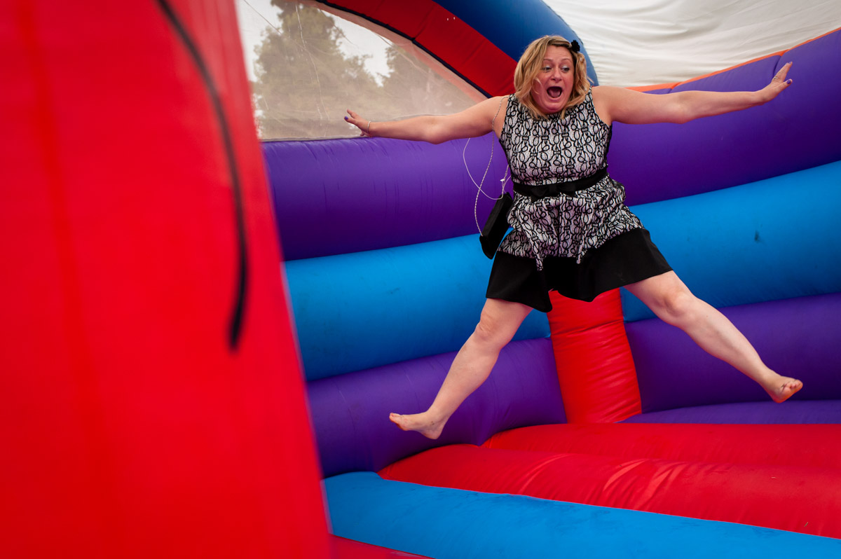 Guest enjoys use of bouncy castle at Latimer Place wedding