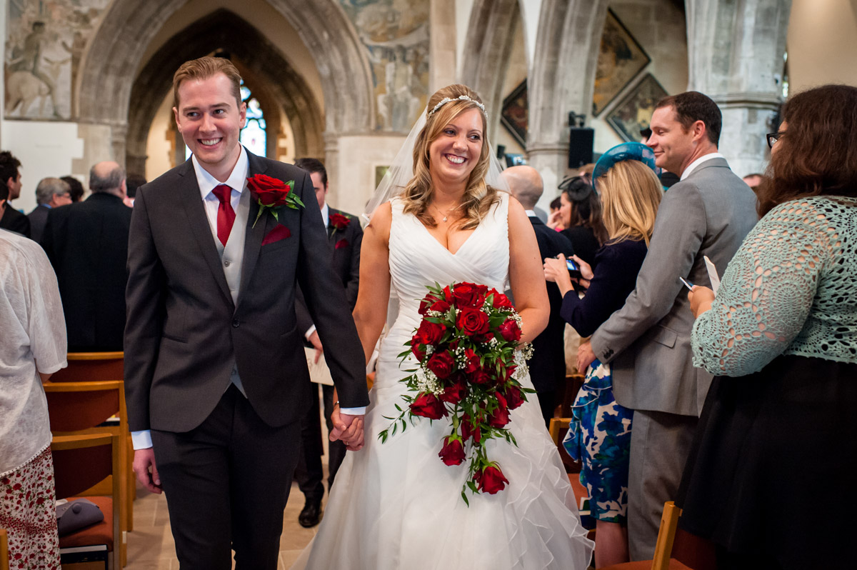 Bride and Groom walk down the aisle after wedding at St Mary's Church Chesham