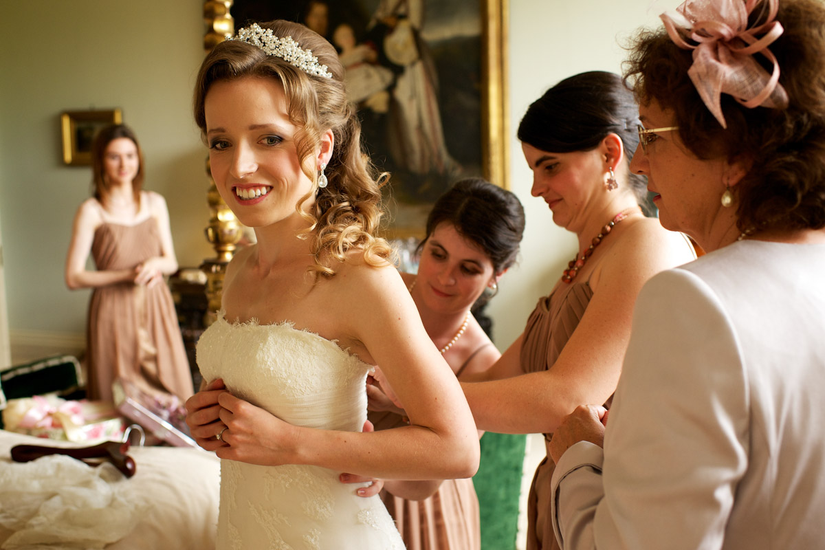 timea has her wedding dress done up by bridesmaids at leeds castle in kent