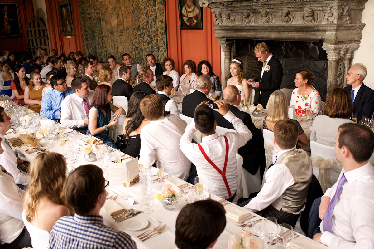 photograph of guests listening to edmund doing his wedding speech at leeds castle in kent