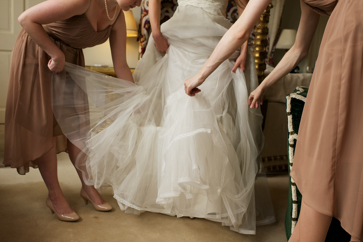 Timeas bridesmaids adjust her wedding dress before her ceremony at leeds castle in kent