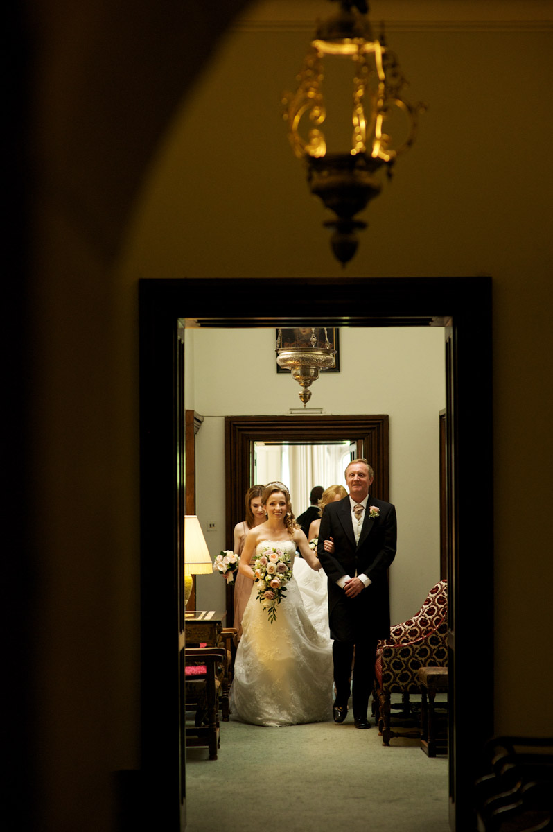 timea and her dad walk down the corridor on her way to her leeds castle wedding ceremony