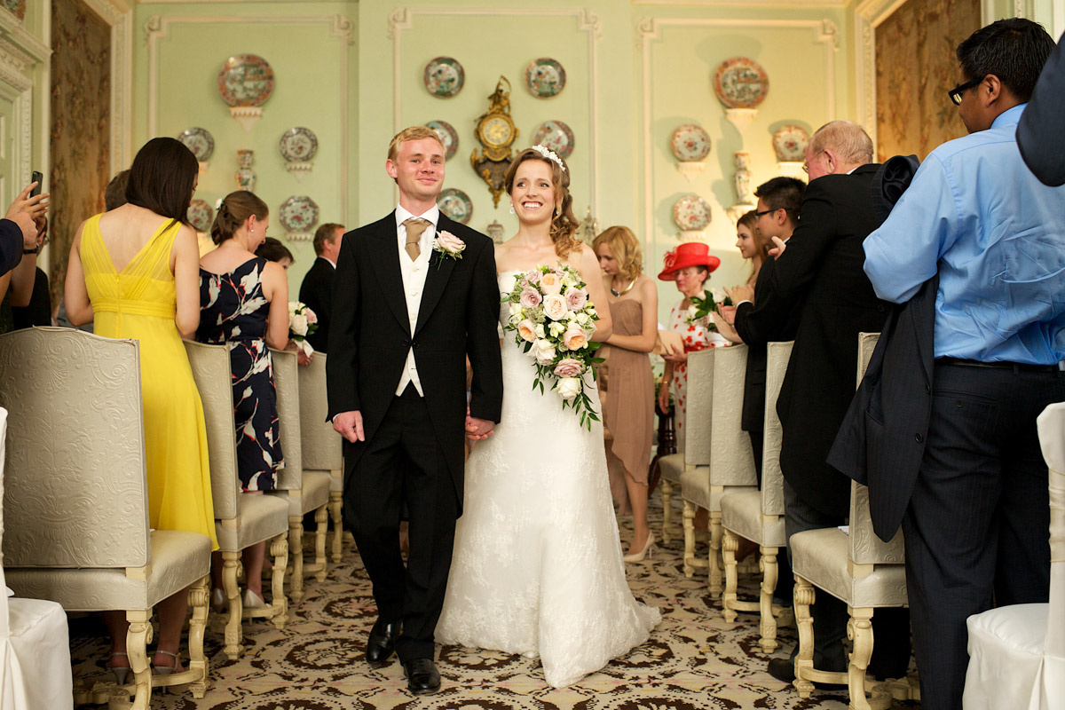 timea and edmund walk down the aisle after their wedding ceremony at leeds castle in kent