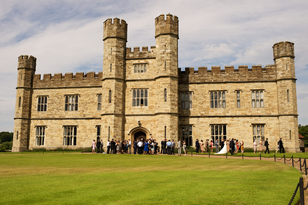 photograph of leeds castle with wedding guests outside