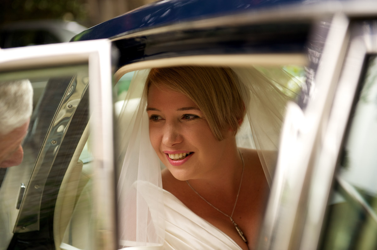 Photograph of sarah arriving at Lympne Castle in a rolls royce for her kent castle wedding
