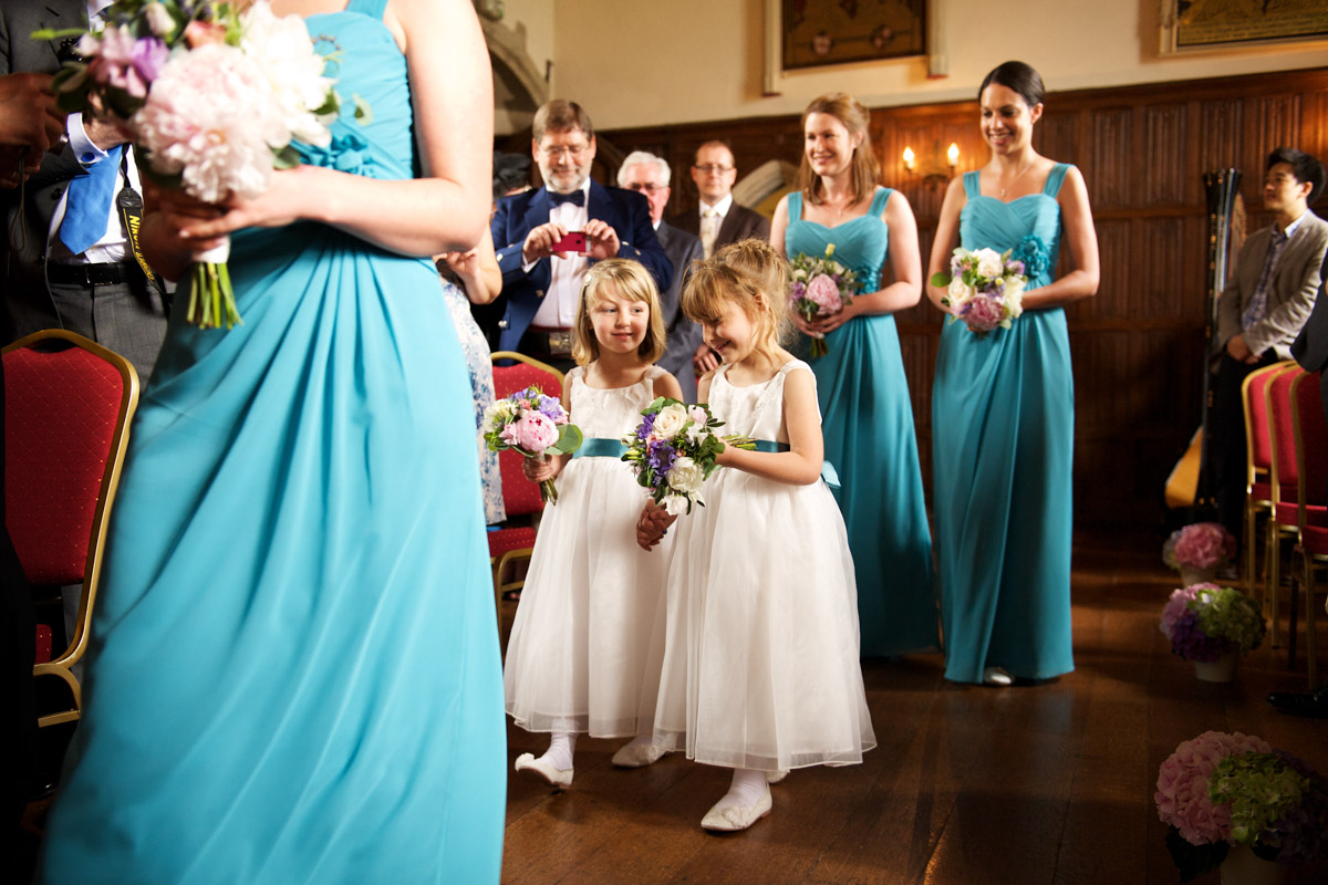 Bridesmaids and flower girls walking down the aisle at lympne castle for Sarah and Leightons wedding