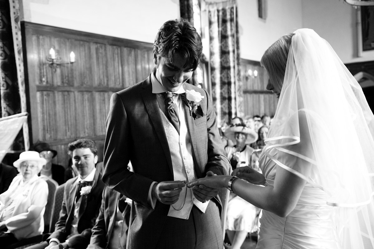Photograph of Leighton putting wedding ring on sarans finger during their Lympne castle ceremony in Kent