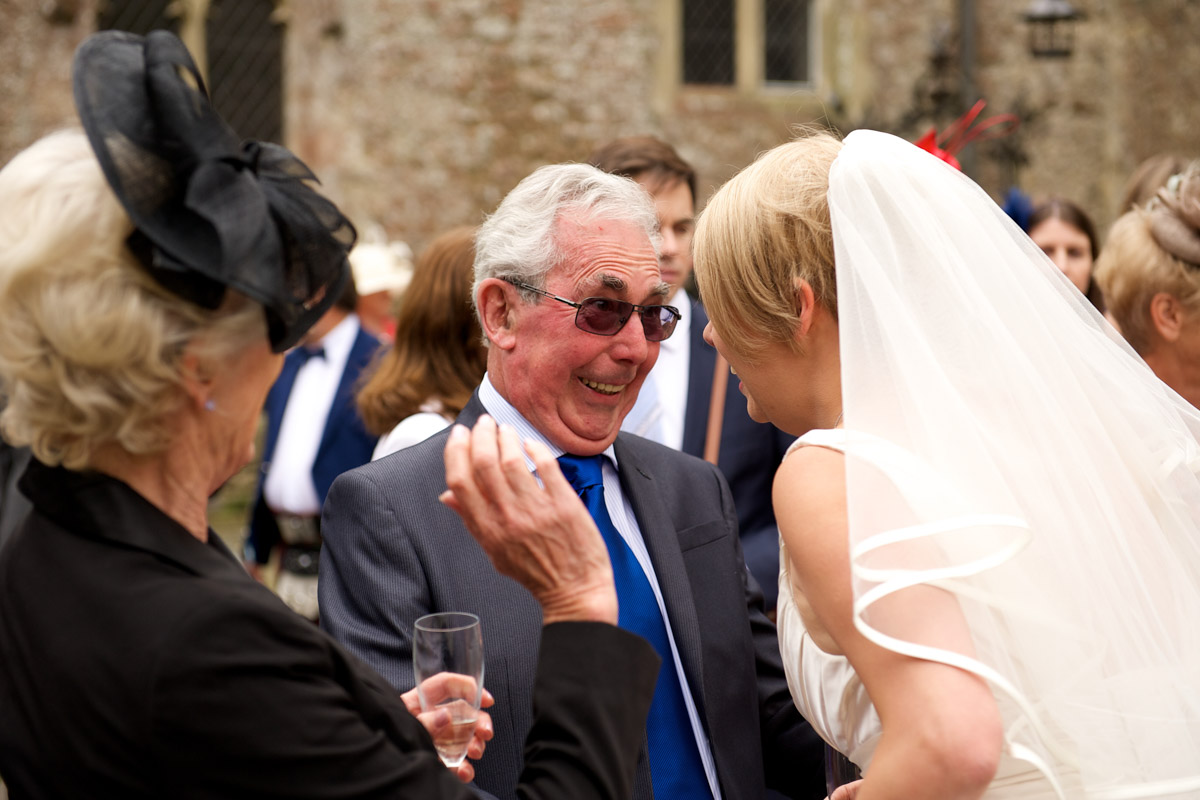 Wedding guests congratulate sarah at Lympne castle in kent on her wedding day