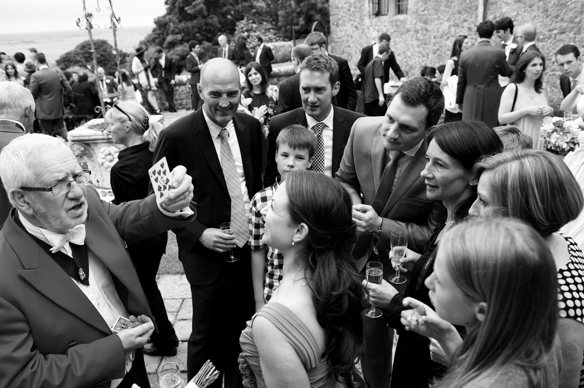 A magician entertains wedding guests at Lympne castle in Kent during Sarah and Leightons wedding reception