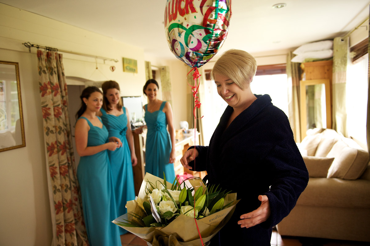 sarah receives bouquet of flowers from Leighton before her wedding at Lympne Castle