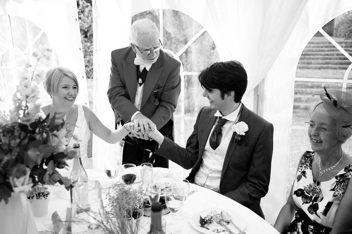 A magician entertains Sarah and Leighton during their wedding reception at Lympne castle in Kent