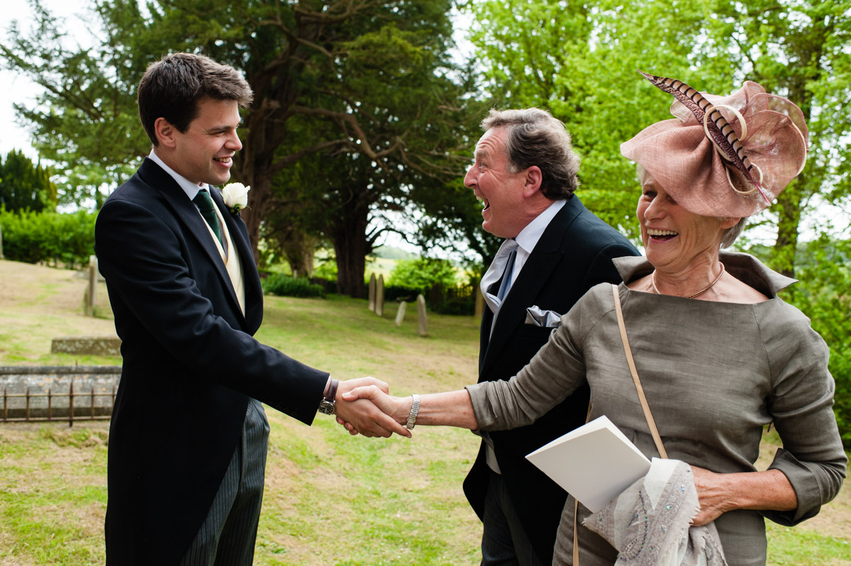 Nick welcomes guests to his wedding at pet ham church in Kent