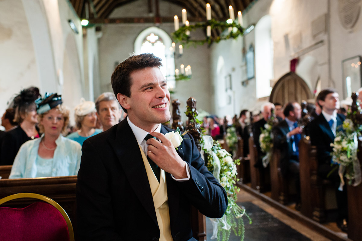 Nick the groom waits for his bride inside petham church in Kent