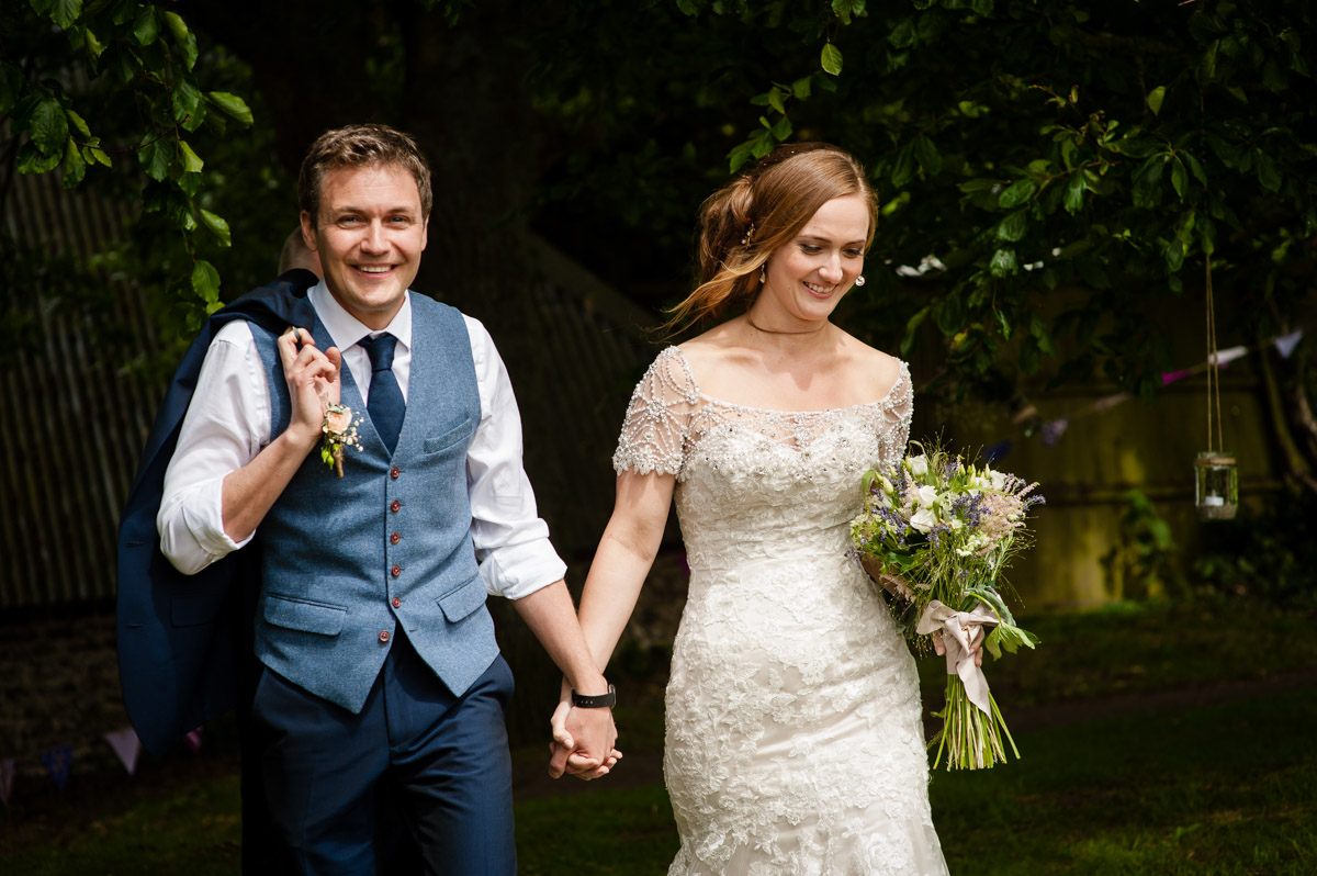 Catherine & Jonny walk hand in hand on their wedding day