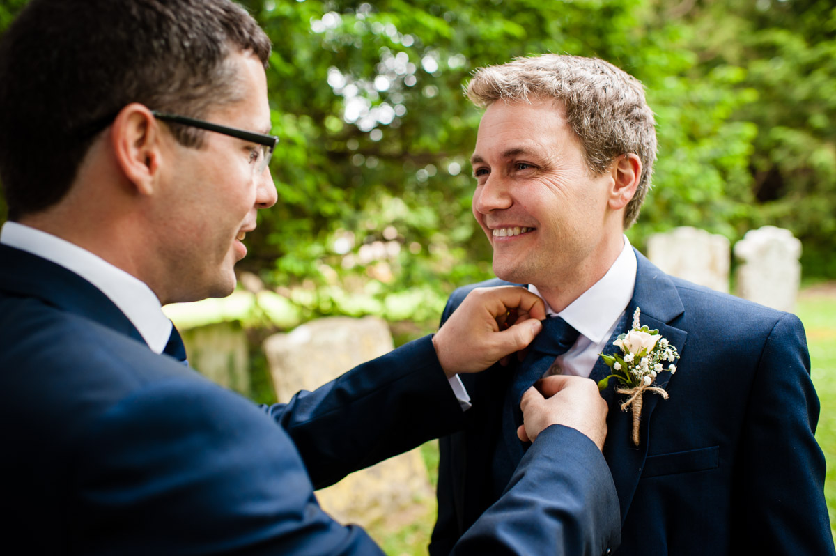 Jonny's best man straightens his tie before his Kent wedding