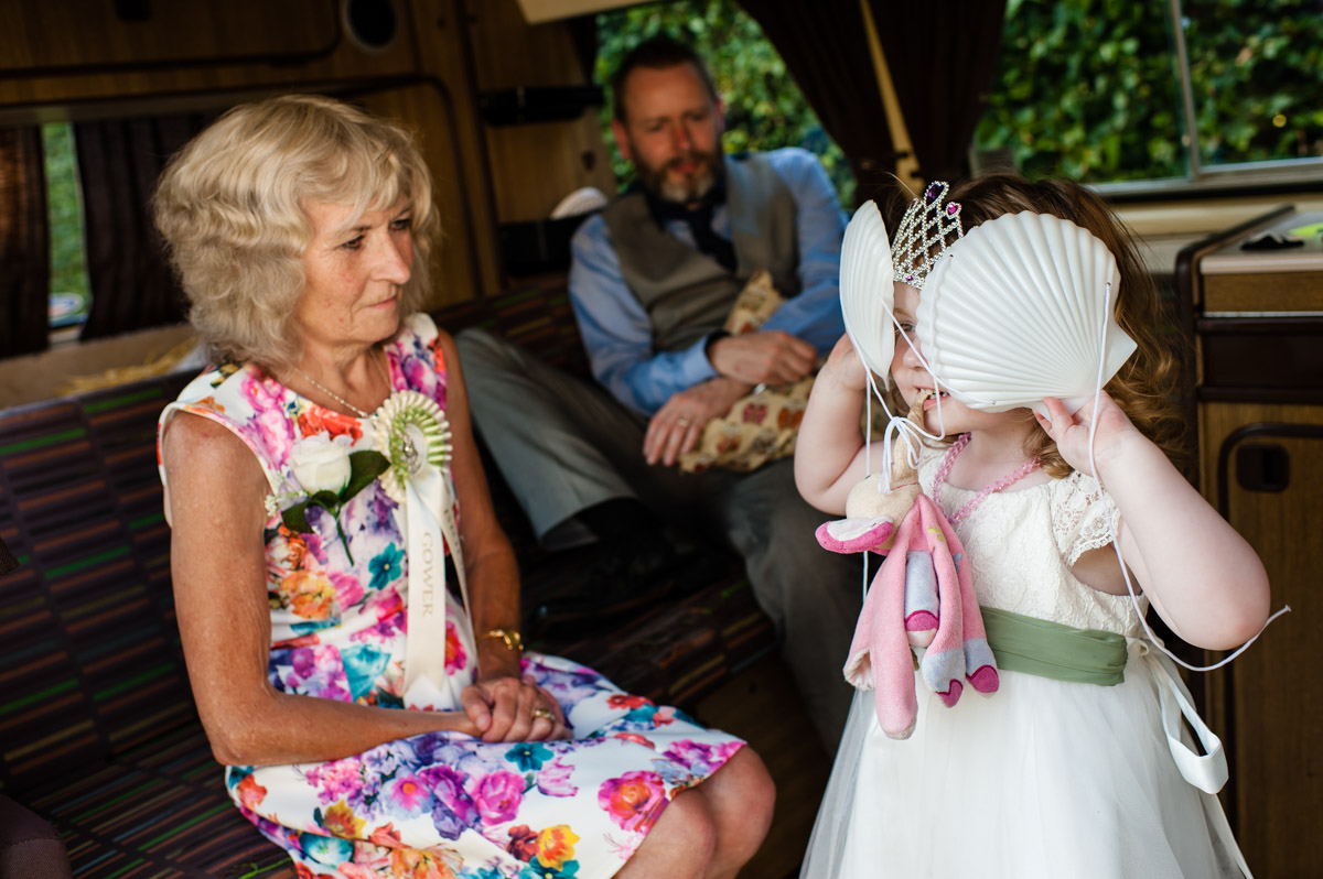 flower girl is photographed playing at selina and marks wedding reception at st augustines priory in kent