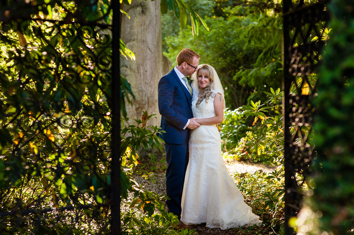 selina and mark are photographed together in the grounds at st augustines priory kent on their wedding day