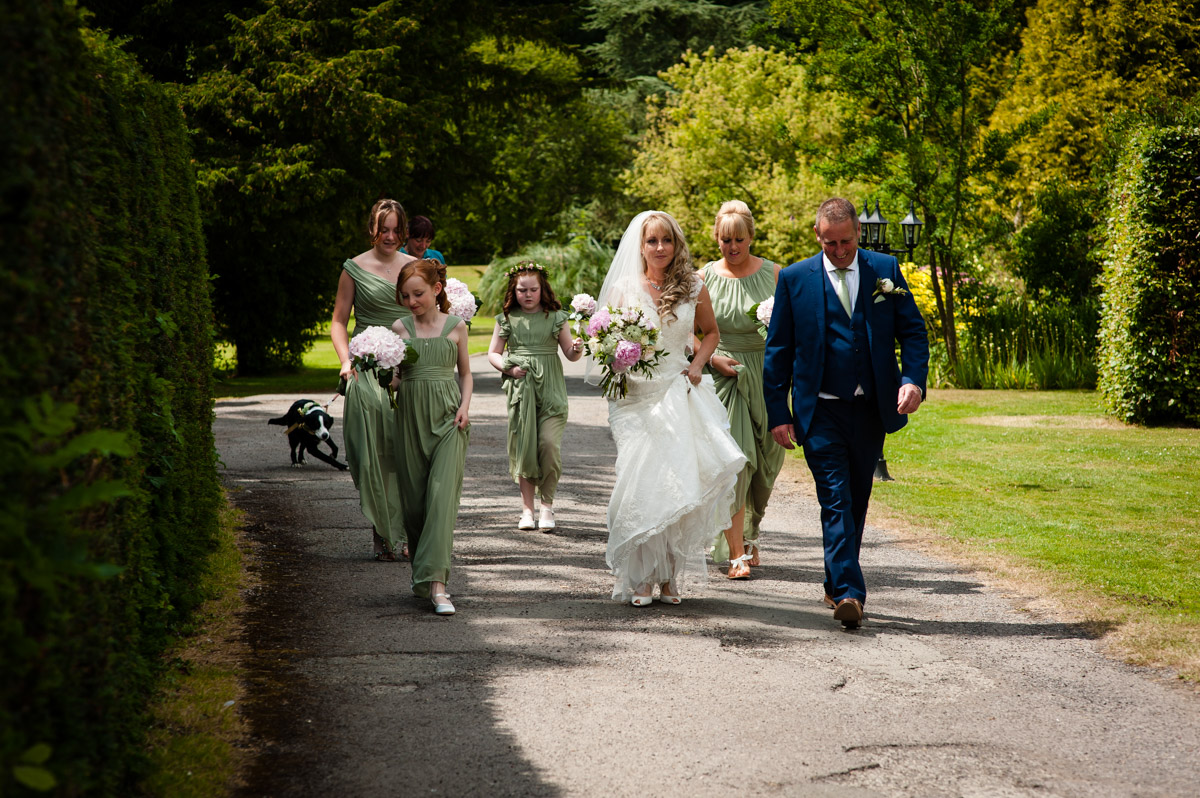 Selina dn her father walk towards St Augustines priory for her wedding ceremony