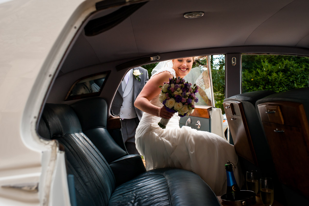 Bride gets into her rolls royce wedding car