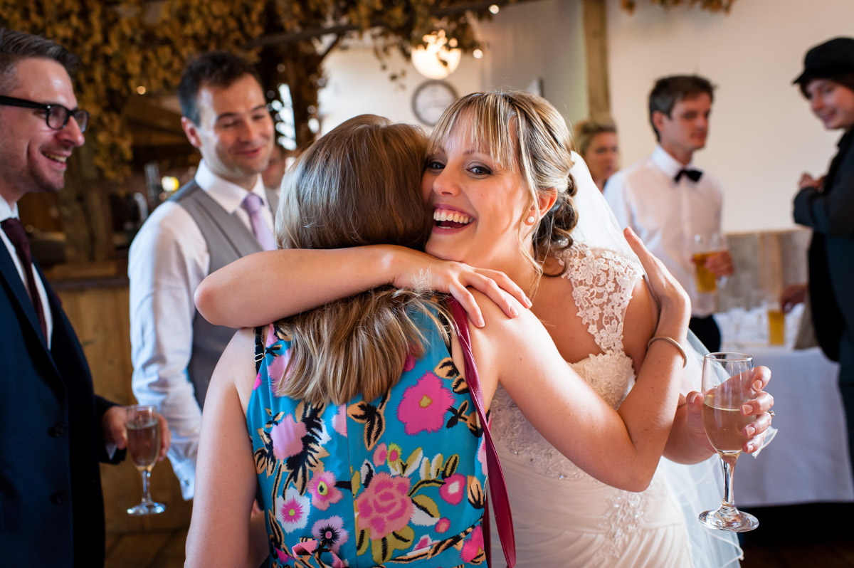 Bride is congratulated by friends at Winters Barn, Canterbury, on her wedding day