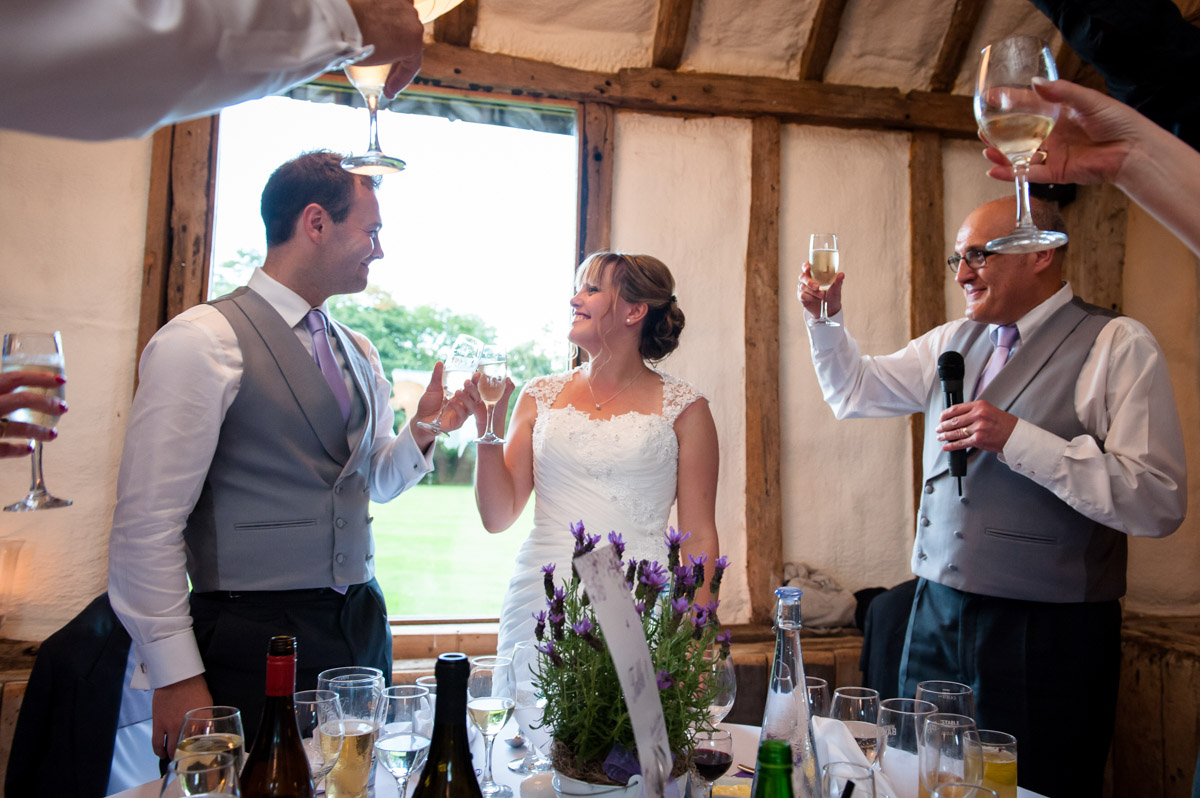Toasting the wedding couple during reception speeches at Winters Barn, Canterbury