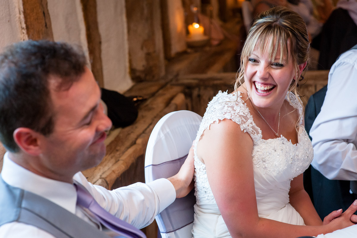 Bride and groom laugh at Best mans speech at Winters Barn